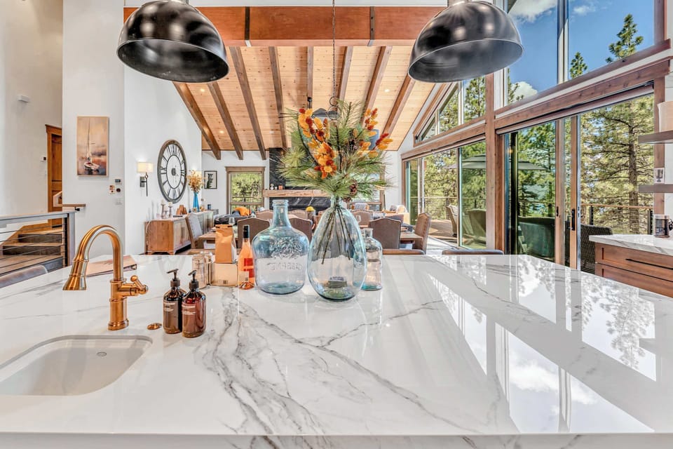 Kitchen area featuring stainless steel appliances and an island with seating for 6.