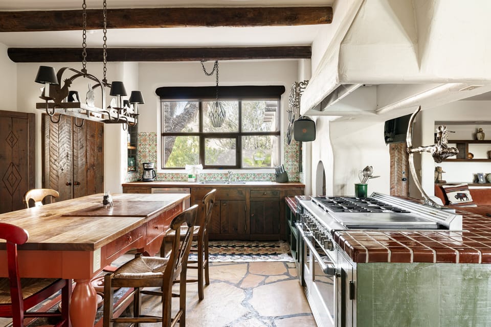 Cook with ease in the gourmet kitchen featuring premium appliances, handcrafted finishes, a spacious island, and plenty of room to gather.