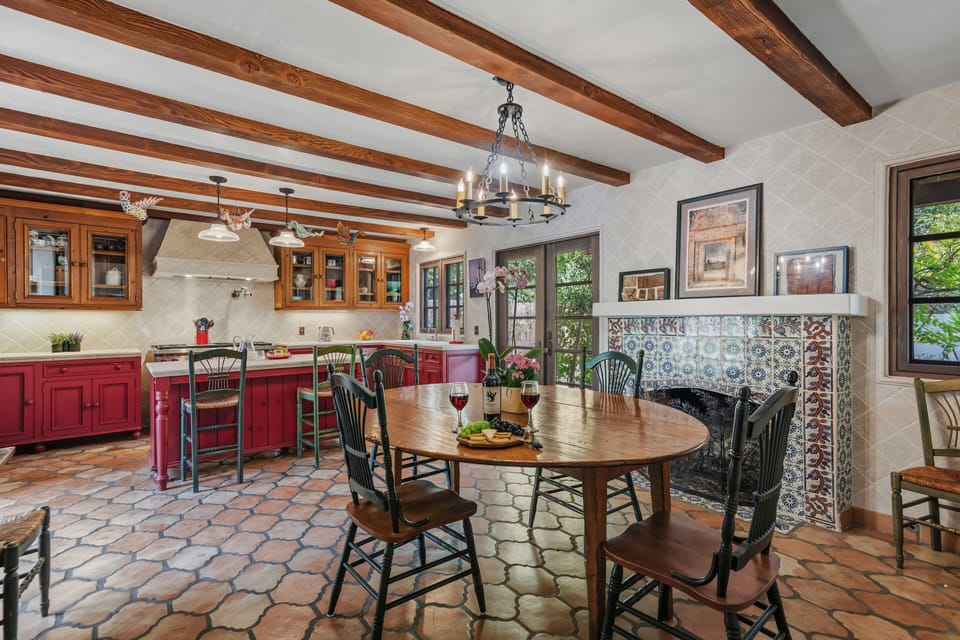 View of dining area and kitchen. Additional fireplace.