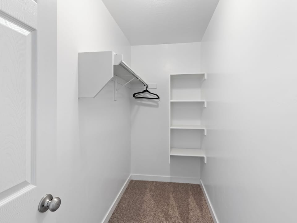 Closet with shelving and hanging space. Ample storage for extended stays.