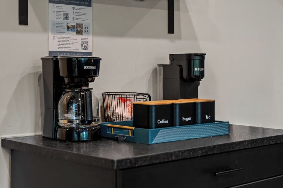 Coffee station with drip coffee maker, Keurig-style brewer, sugar, and coffee supplies for convenient mornings.