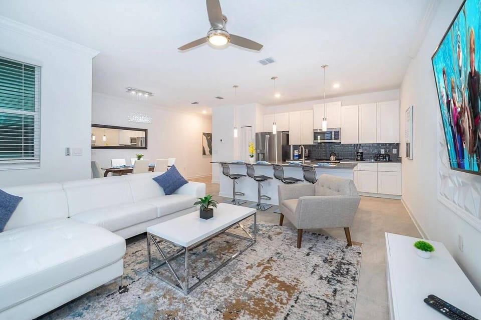 Bright modern living space with open kitchen and island seating