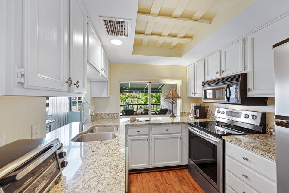 The fully equipped kitchen with granite countertops makes everything from morning coffee to a full family dinner feel easy