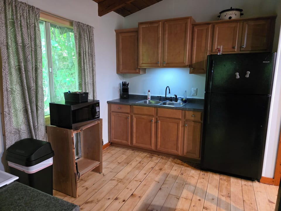microwave, kitchen visible, indoor, coffee and or coffee maker, refrigerator