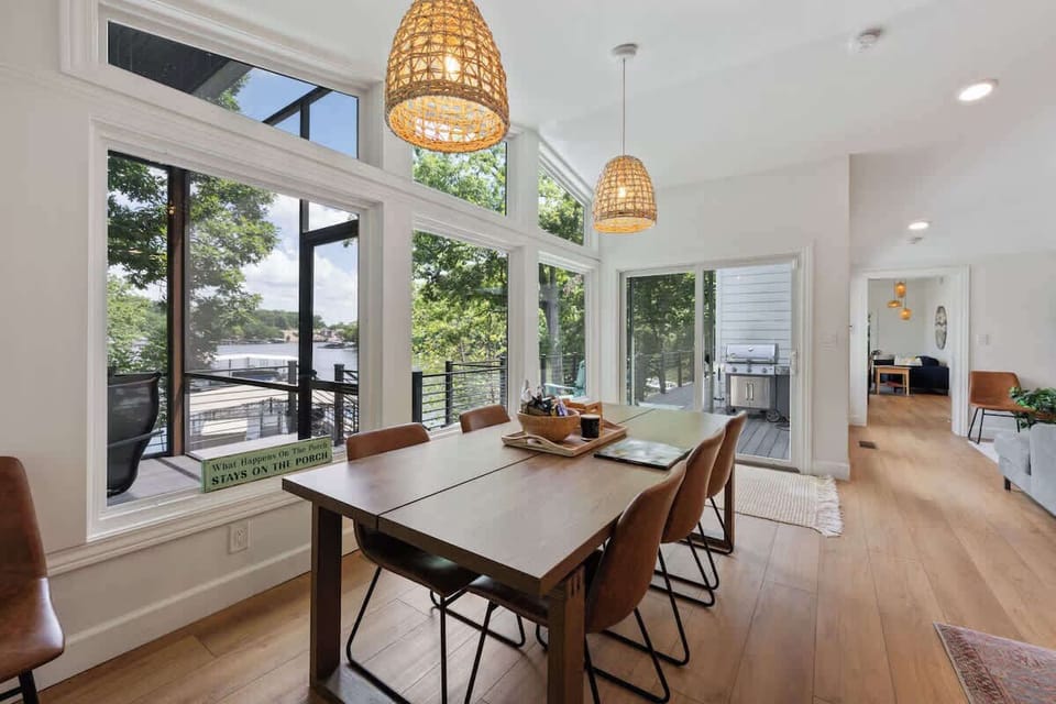 Bright dining area with large windows and peaceful wooded views.