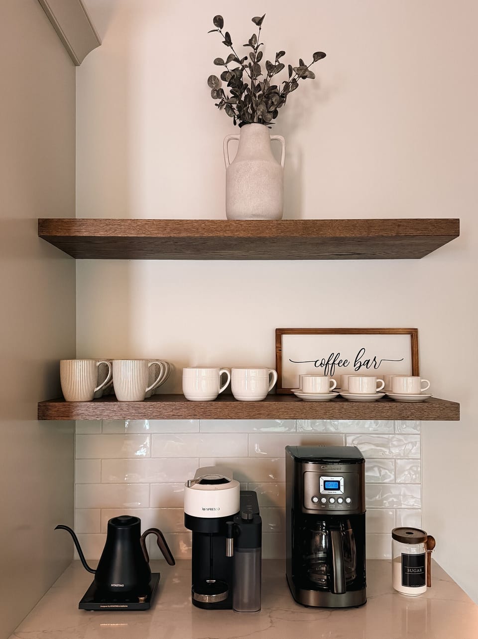 Chic coffee bar with drip, single-serve, mugs, and warm designer touches