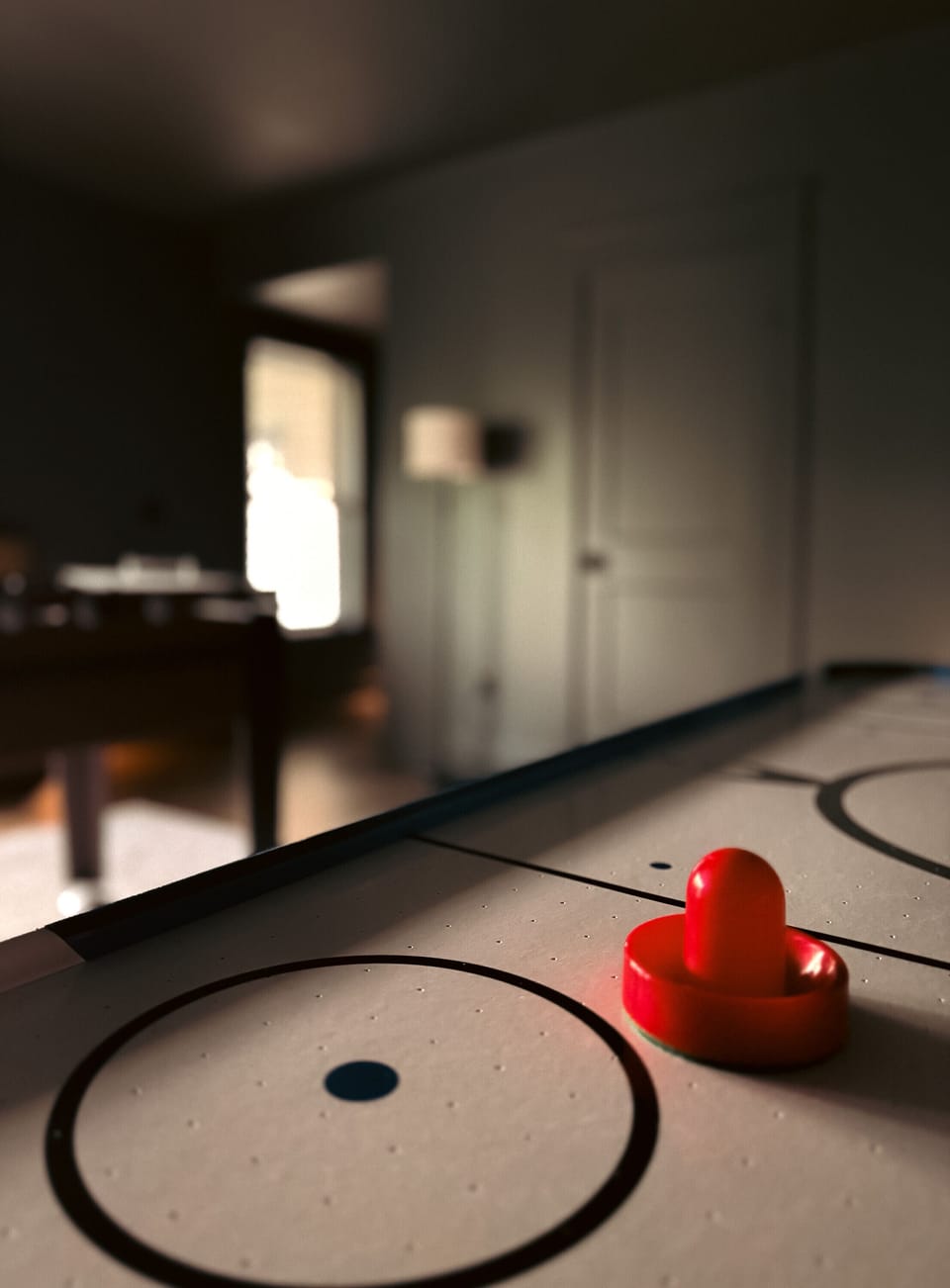 Fun indoor game room with tabletop air hockey for cozy guest entertainment