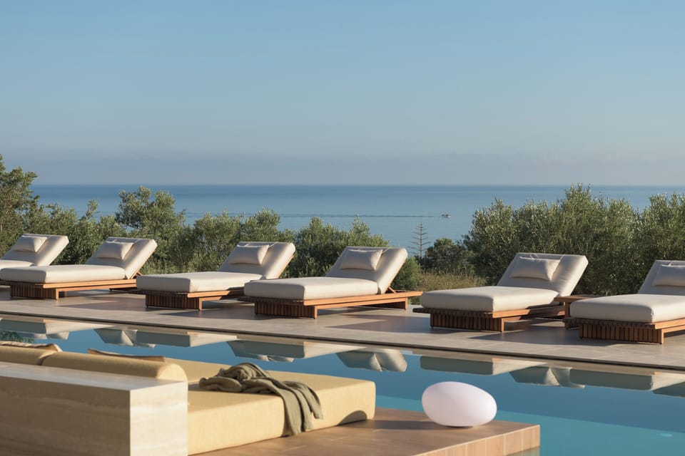 A 100 m² infinity pool shaped for slow swims, sea-view serenity, and sunlit mome