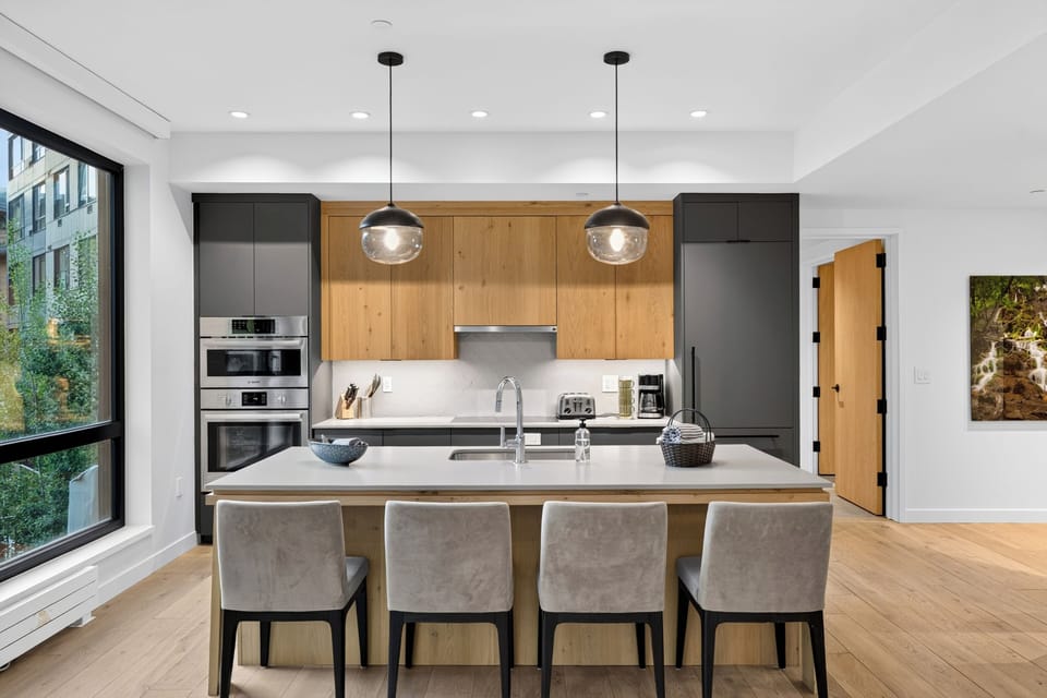 Symmetrical view of the streamlined, state-of-the-art kitchen cabinetry and integrated appliances.