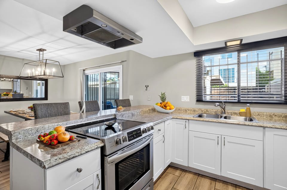 Bright kitchen with granite counters, stainless steel appliances, and plenty of prep space.