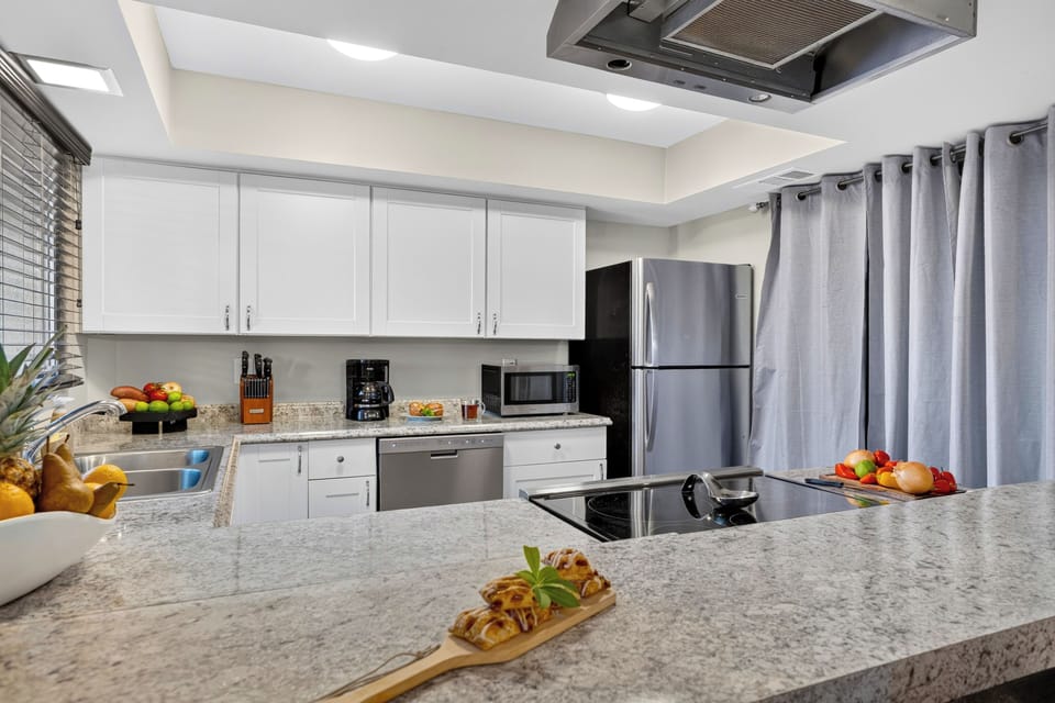 Bright kitchen with granite counters, stainless steel appliances, and plenty of prep space.