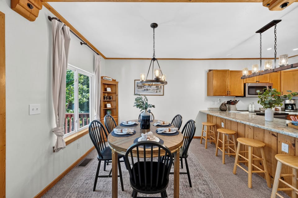 The dedicated dining area seats six comfortably, framed by large windows that bring the scenic outdoors inside.