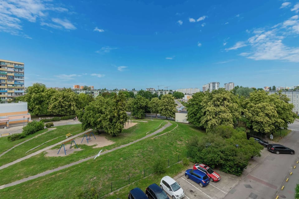 A peaceful view of the surrounding neighborhood and greenery. Open spaces and trees provide a pleasant atmosphere.