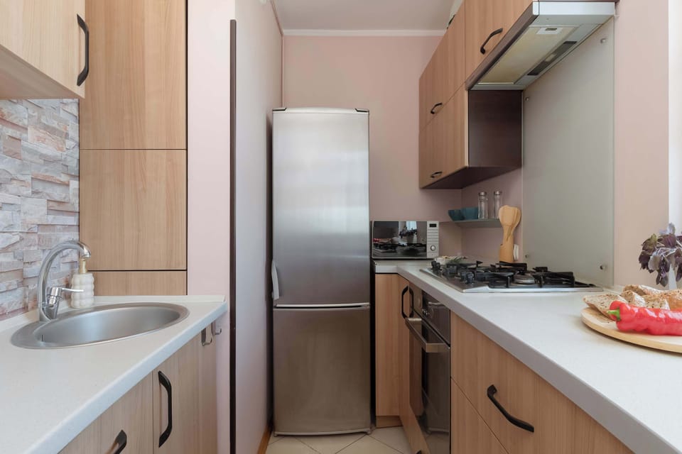 A functional kitchen with a refrigerator, stovetop, and plenty of counter space. Natural light makes the room feel bright and welcoming.