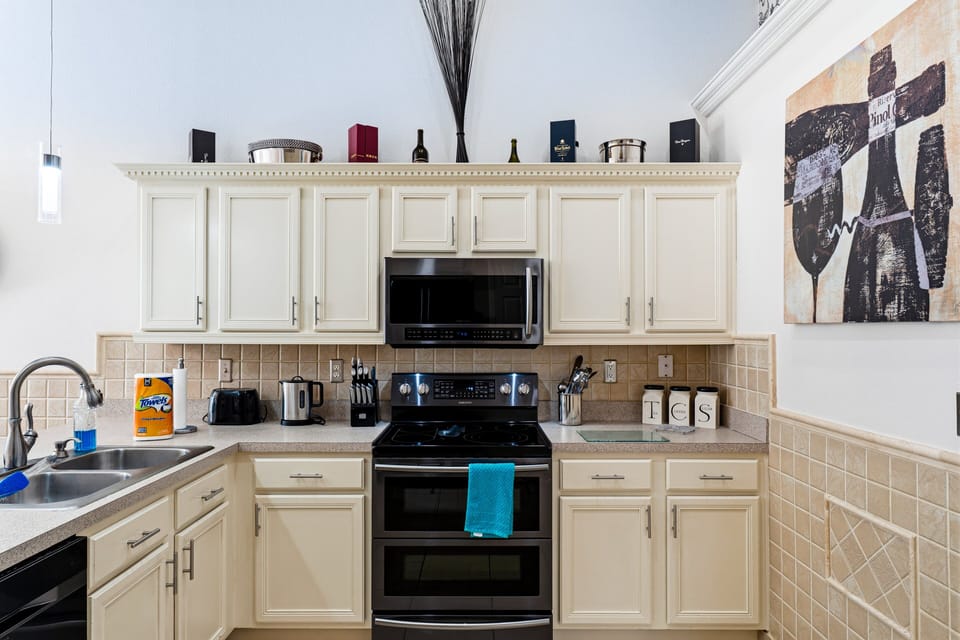 Modern, fully equipped kitchen with breakfast bar, quality appliances, and everything you need to prepare meals, snacks, and drinks throughout your stay.