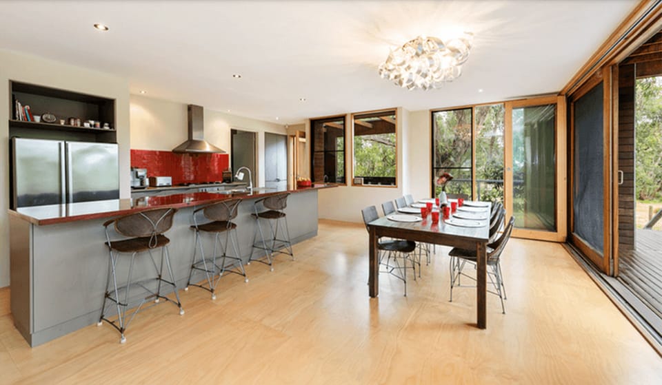 Bright open-plan kitchen and dining with breakfast bar and garden views