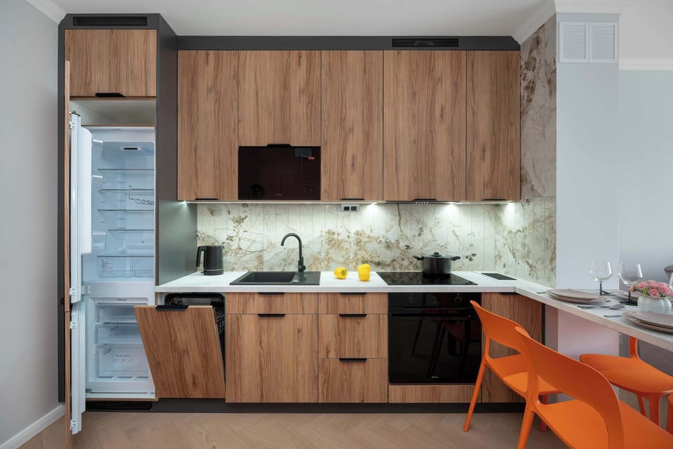 Modern kitchen featuring integrated appliances, ample storage, and elegant finishes.