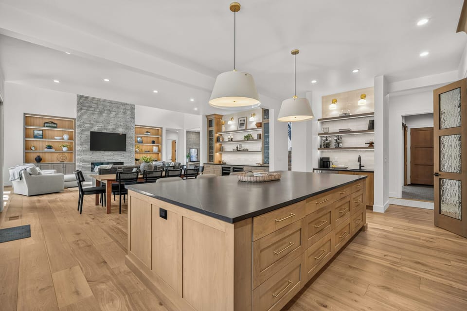 Step into this stunning open-concept space where your vacation days unfold in style. Gather around the expansive kitchen island, relax in the bright living area, and enjoy seamless flow throughout your home away from home.