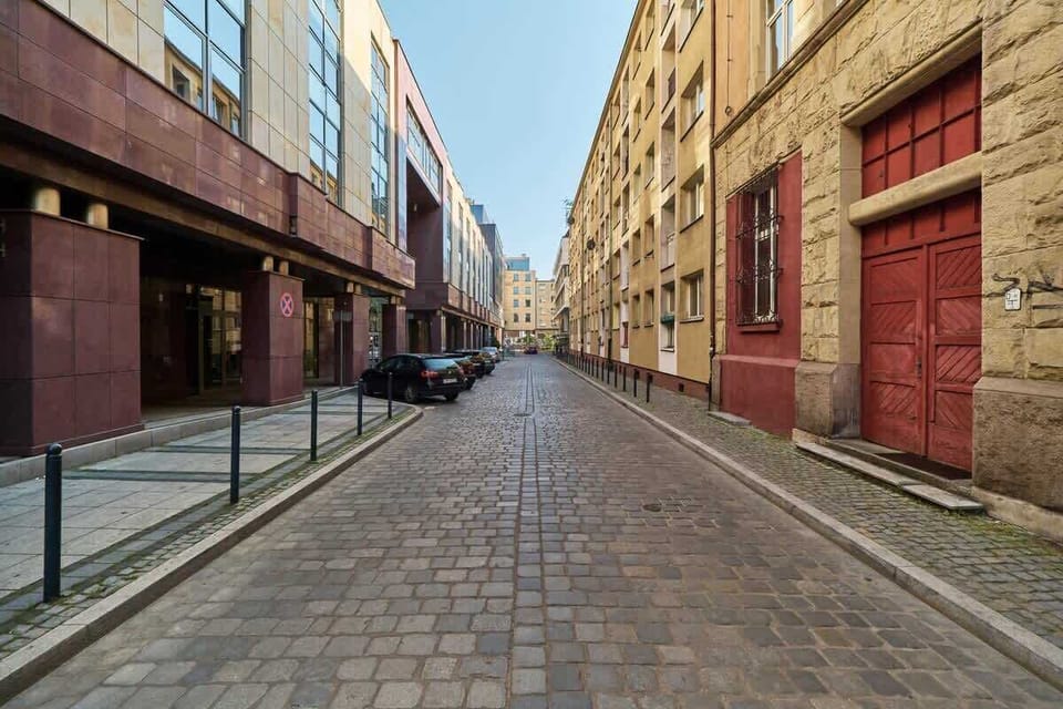 A charming cobblestone street lined with colorful buildings, offering a lively yet calm vibe.