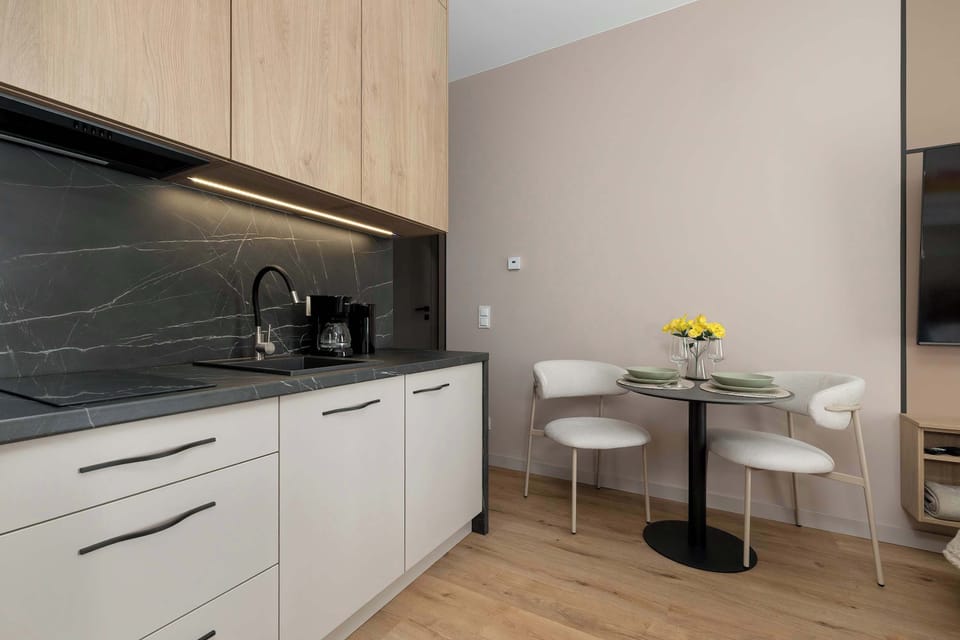 The sleek design of the kitchenette blending seamlessly with the living area.