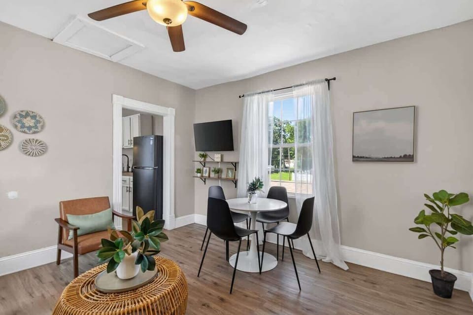 Bright dining nook with natural light, modern seating, stylish décor, and easy access to the kitchen.