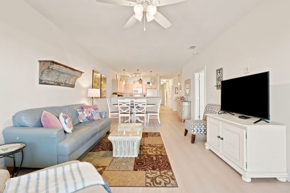 Unwind in your bright, breezy open-plan living space where soft coastal colors and thoughtful decor create a welcoming retreat for memorable vacation moments.
