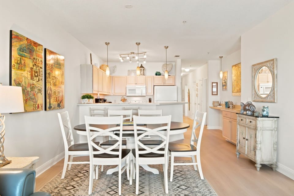 Step into your bright, open-concept living space where artful touches and warm wood finishes create an inviting atmosphere. Gather around the spacious dining table for meals together, while the well-appointed kitchen stands ready for your culinary adventur