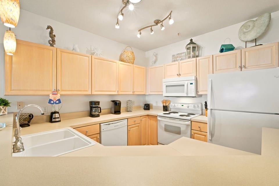 Step into your fully equipped kitchen, where coastal charm meets convenience. With ample counter space and all the appliances you need, preparing your favorite meals becomes a delightful part of your beach getaway.