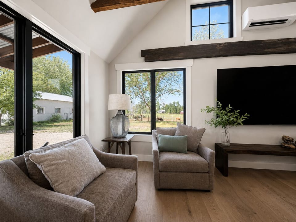Sink into plush seating beneath rustic beams and catch up on your favorite shows. Natural light fills the room through expansive windows, while the AC keeps you comfortable year-round.