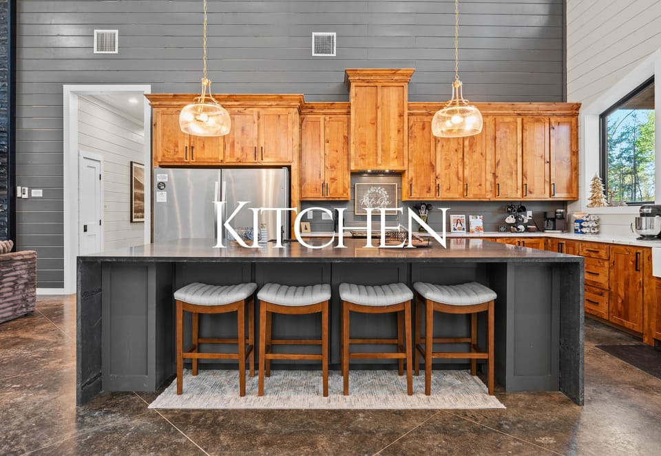 The spacious kitchen features a large island with plenty of seating, making it the perfect spot for everything from quick breakfasts to family dinners.