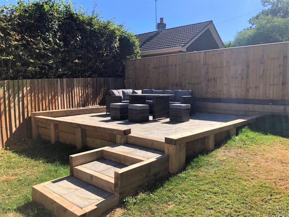 An enclosed rear garden with patio area