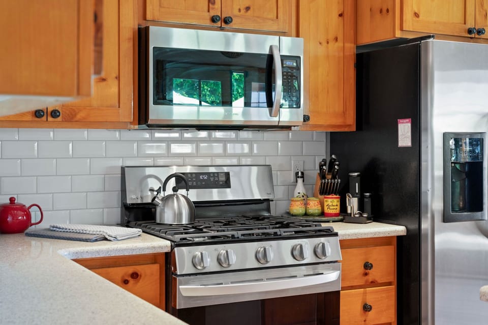 Your fully equipped kitchen features stainless steel appliances, a gas stove, and charming natural wood cabinetry—ready for you to prepare meals and gather with loved ones in comfort.