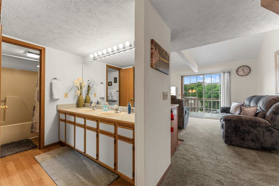 The main-level full bath offers a double vanity & shower/tub combo​
