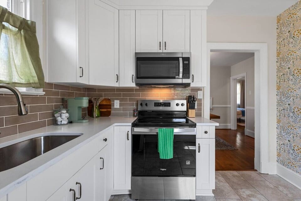 This freshly renovated kitchen offers everything you need, from an electric stove and microwave to a Keurig and full fridge/freezer. With easy access to the upstairs loft and dining area, it’s designed for convenience and connection.