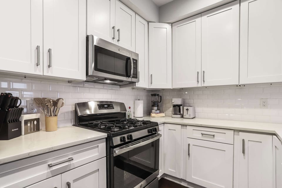 Modern, updated kitchen equipped with full-size appliances, cookware, and everything for home-cooked meals 