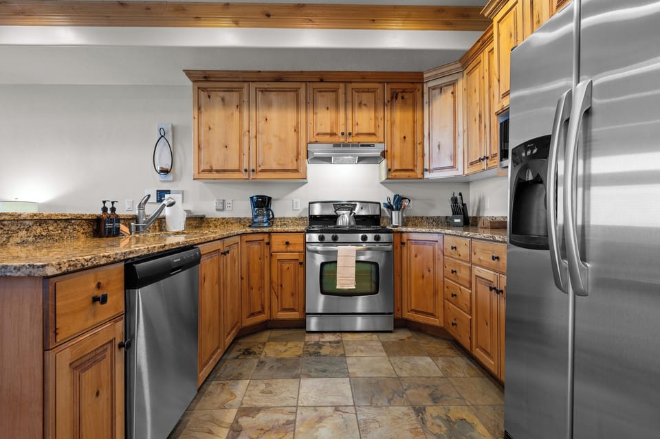 Modern kitchen featuring granite countertops and stainless steel appliances.
