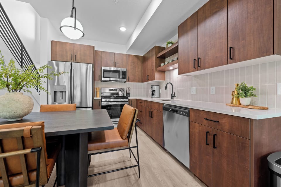 Fully equipped kitchen with stainless steel appliances and ample counter space.