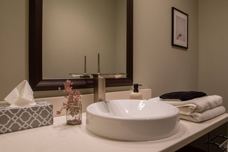 Communal bathroom with shower stall and resort-style fixtures
