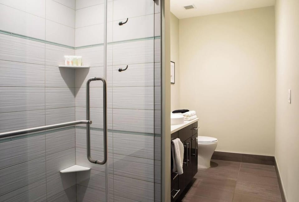 Communal bathroom with shower stall and resort-style fixtures