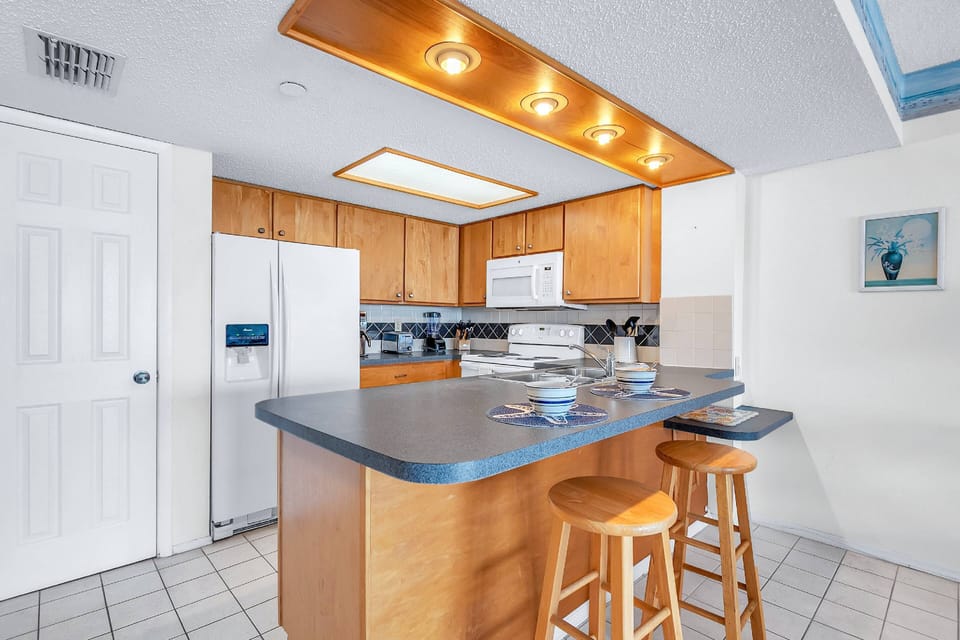 Fully stocked kitchen with a breakfast bar