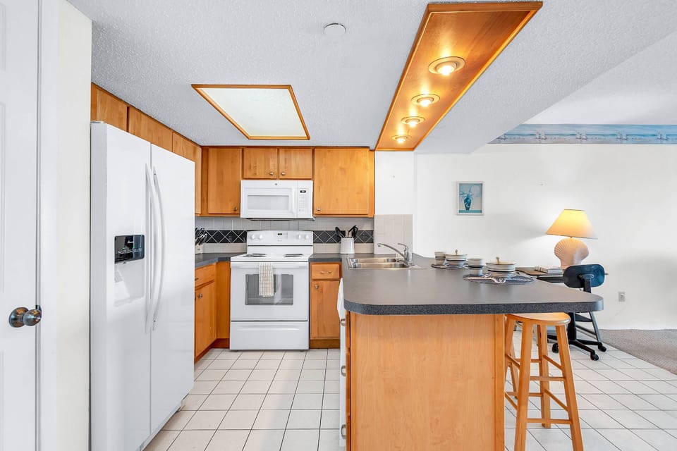 Over sized refrigerator and kitchen view
