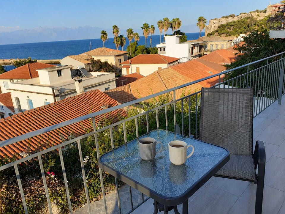 Scenic Balcony Dining Area Overlooking Traditional Koroni Rooftops