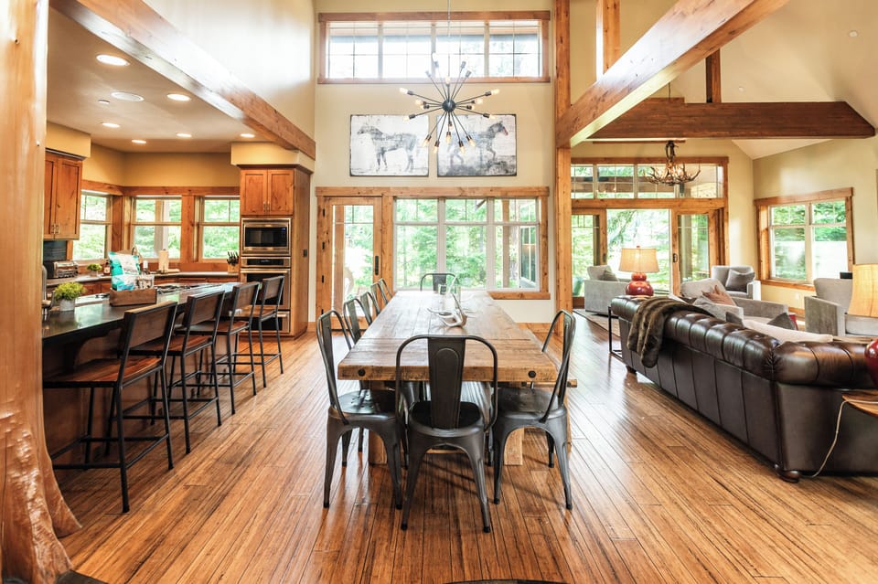 Soaring timber ceilings, an oversized dining table, and an open-concept layout designed for gathering.