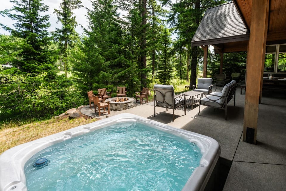 Relax in the private hot tub, gather around the fire pit, or unwind beneath the covered outdoor lounge.