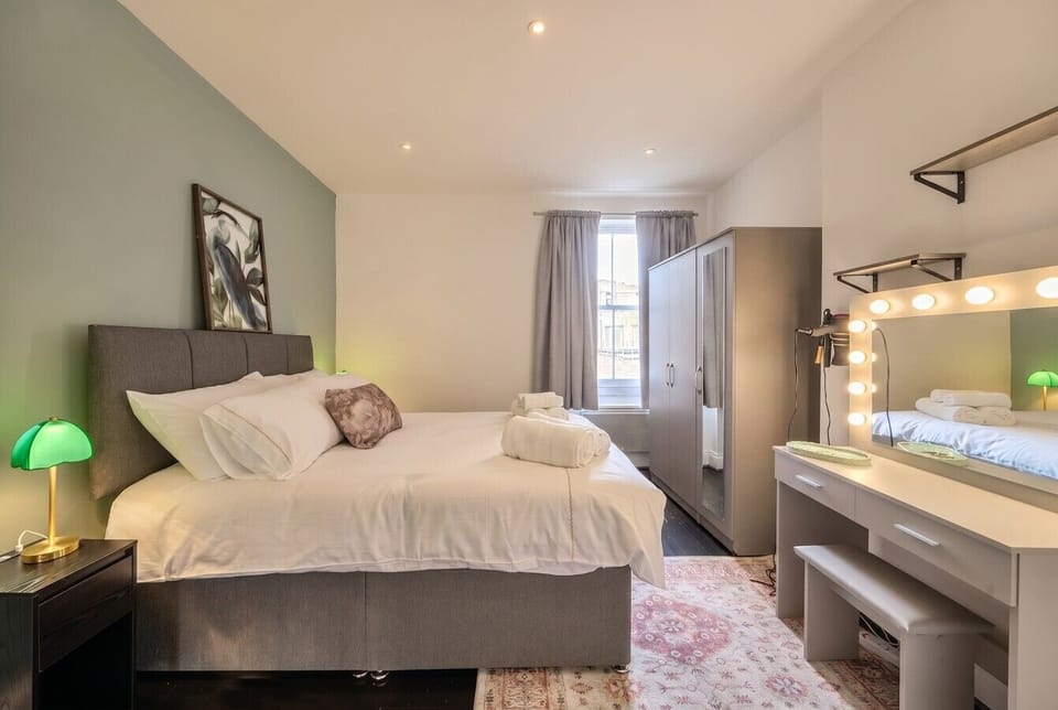 Serene double room with dressing table and warm mirror lighting