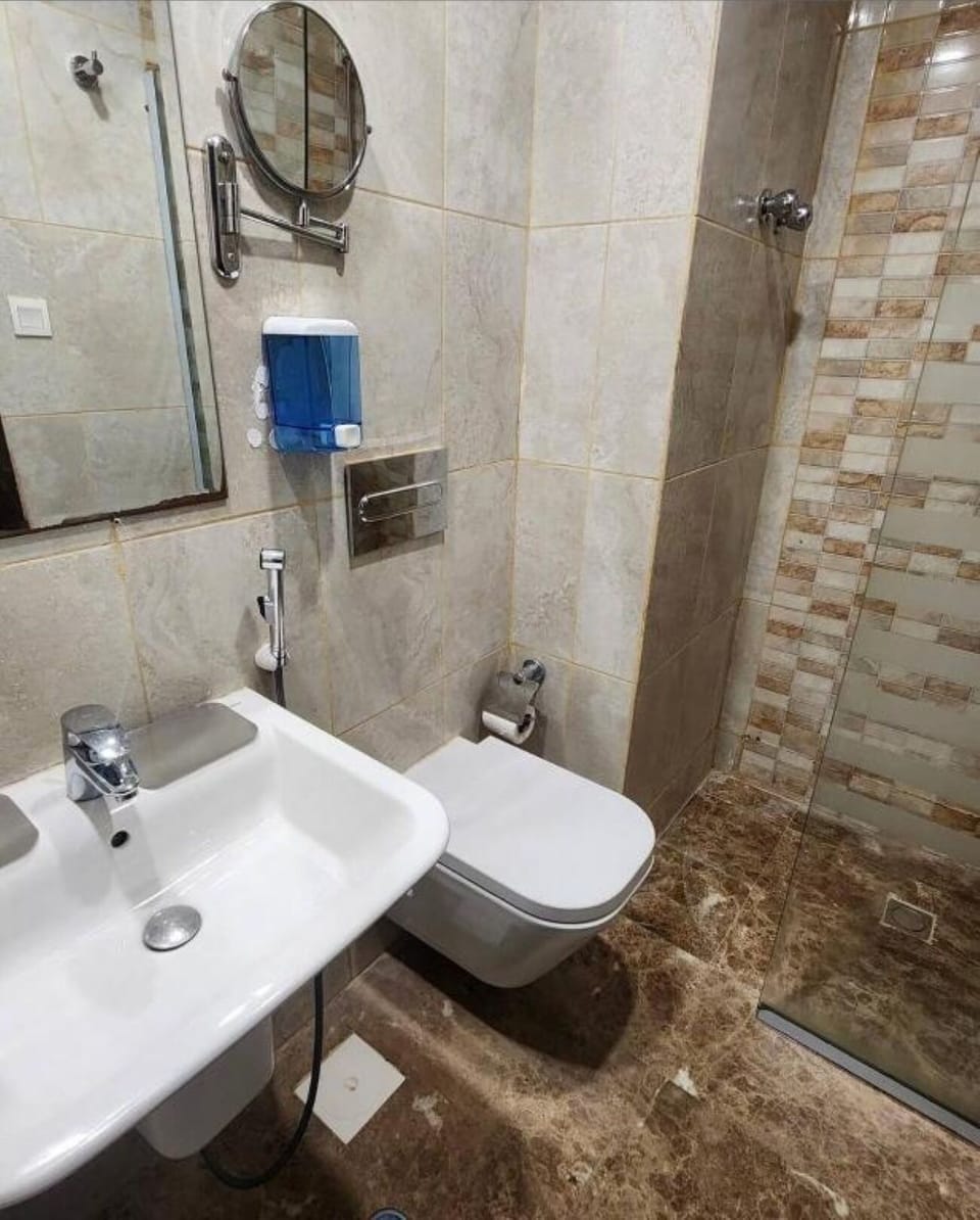 Shower, hair dryer, slippers, towels