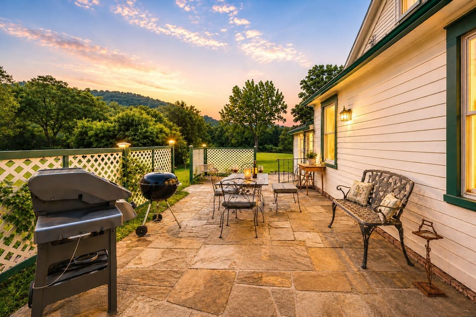 Private stone patio with grill and outdoor dining.
