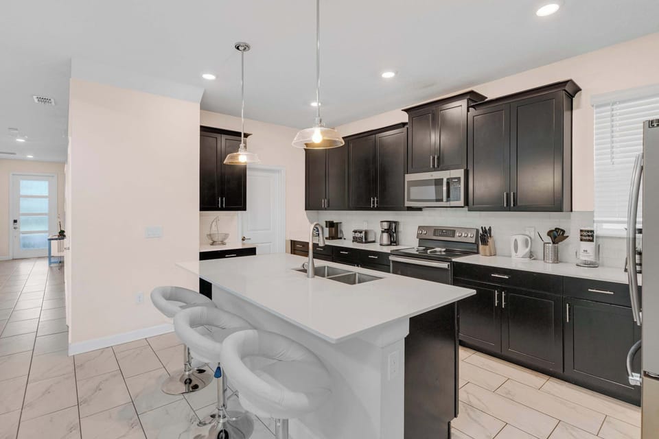 Cook, snack, and gather with ease in the fully equipped kitchen with a large island and plenty of prep space.