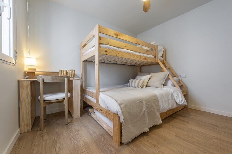 Bunk bedroom with workspace and natural light