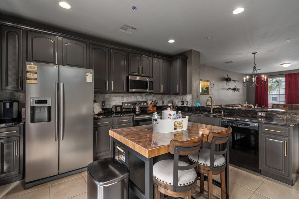 Every magical adventure needs a feast ✨ Our spacious, fully stocked kitchen features a large island, stainless steel appliances, plenty of seating, and everything you need to cook, snack, and gather together